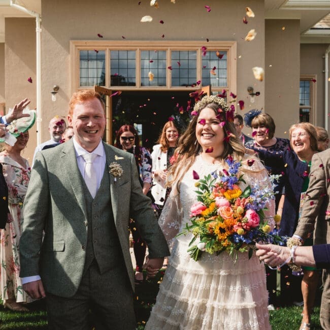 bride and groom exiting conffeti at burtonfields hall york