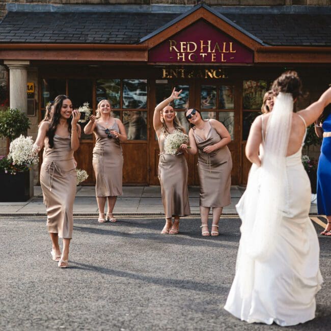 bride walking down to entrance at red hall hotel