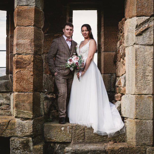 Danby casle ruins with bride and groom inside