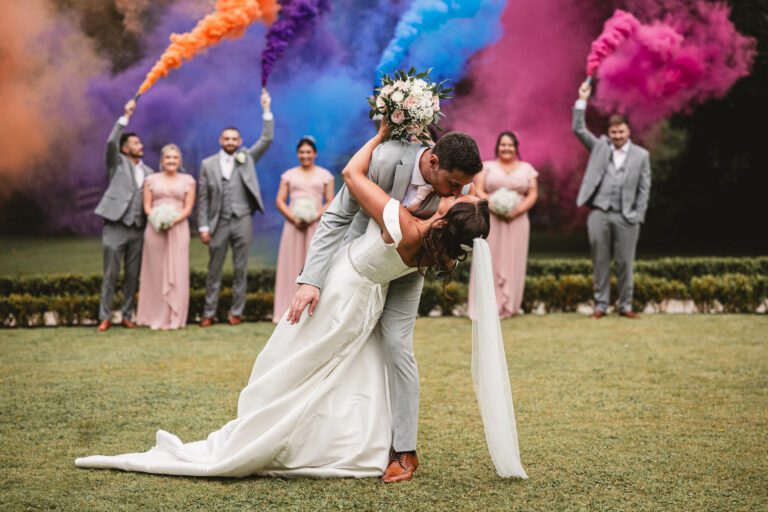 Smoke bombs at a wedding as groom dips the bride at East riddlesden hall | East riddlesden hall wedding photographer