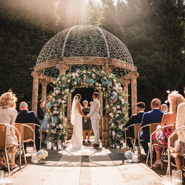 Sun shining on couple as the getting married at saddlworth hotel for the outdoor ceremony | West Yorkshire Wedding photographer