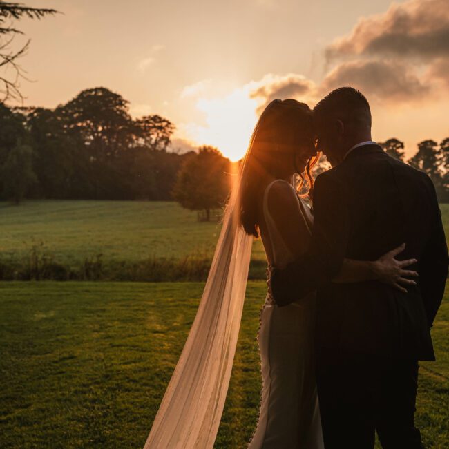 A golden hour sunset photo of a bride and groom taken at tissington hall | Yorkshire wedding photographer