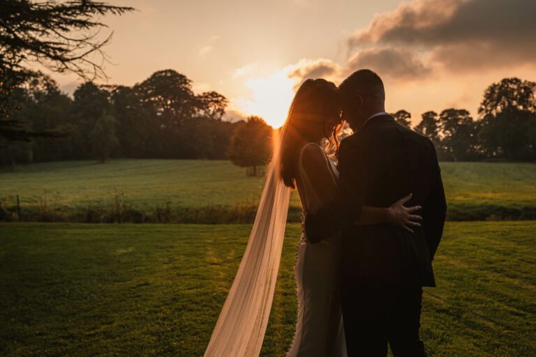 A golden hour sunset photo of a bride and groom taken at tissington hall | Yorkshire wedding photographer