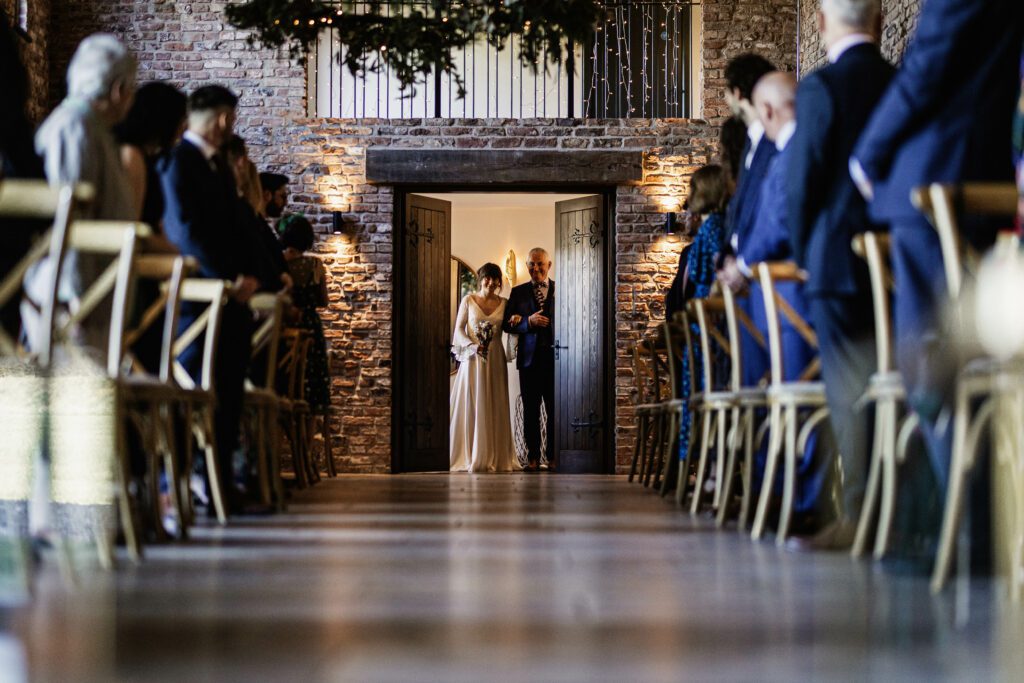 Bride walking down the aisle at Thirsk lodge barn | North Yorkshire wedding photographer