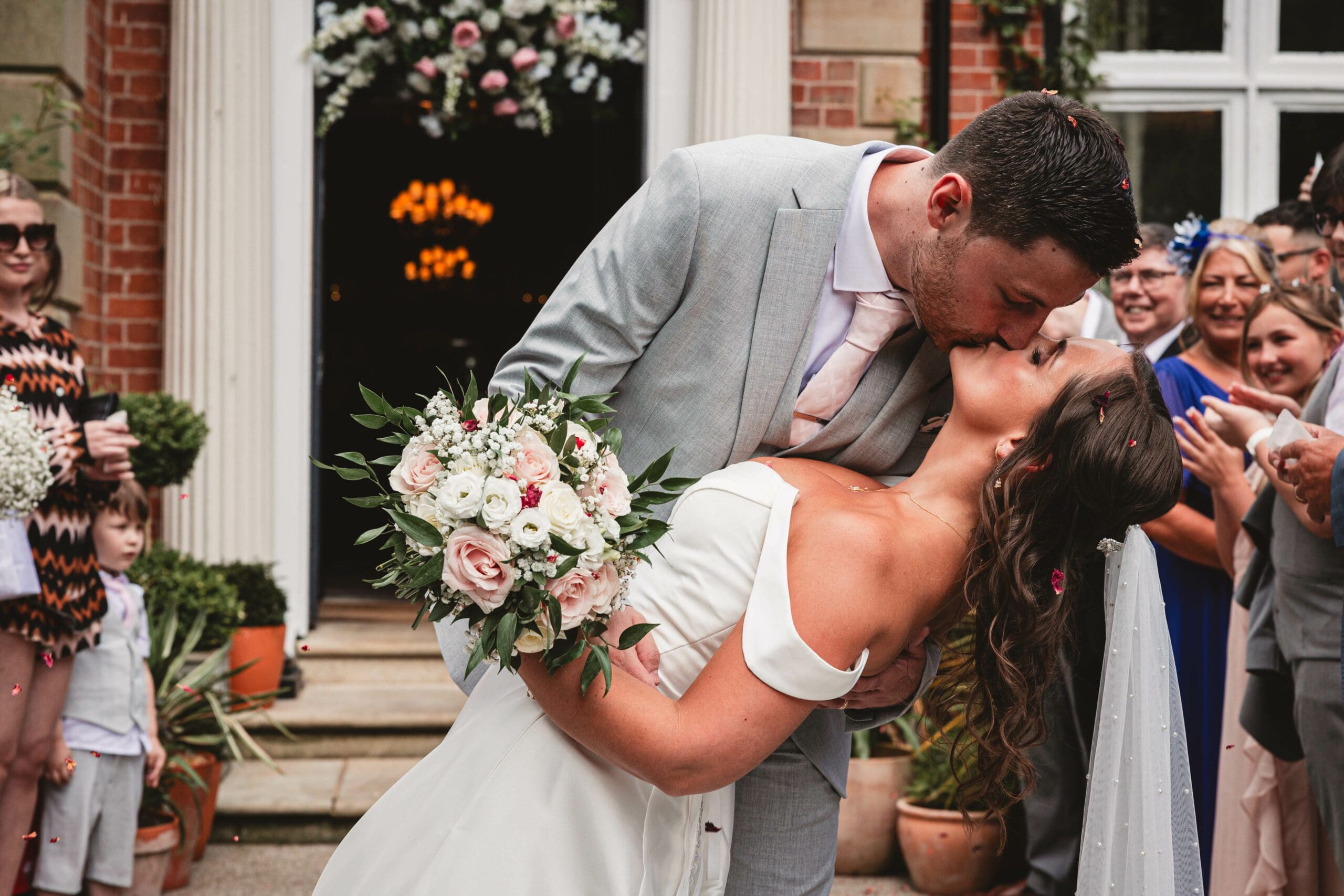 A Groom dipping his bride at ashfield house during the confetti photos at ashfield house for their wedding day | Yorkshire wedding photographer