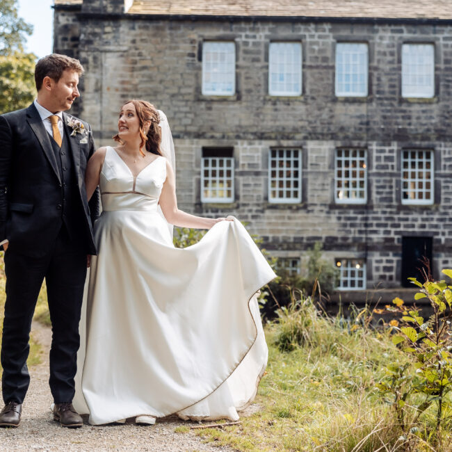 bride and groom with gibson mill in the rear