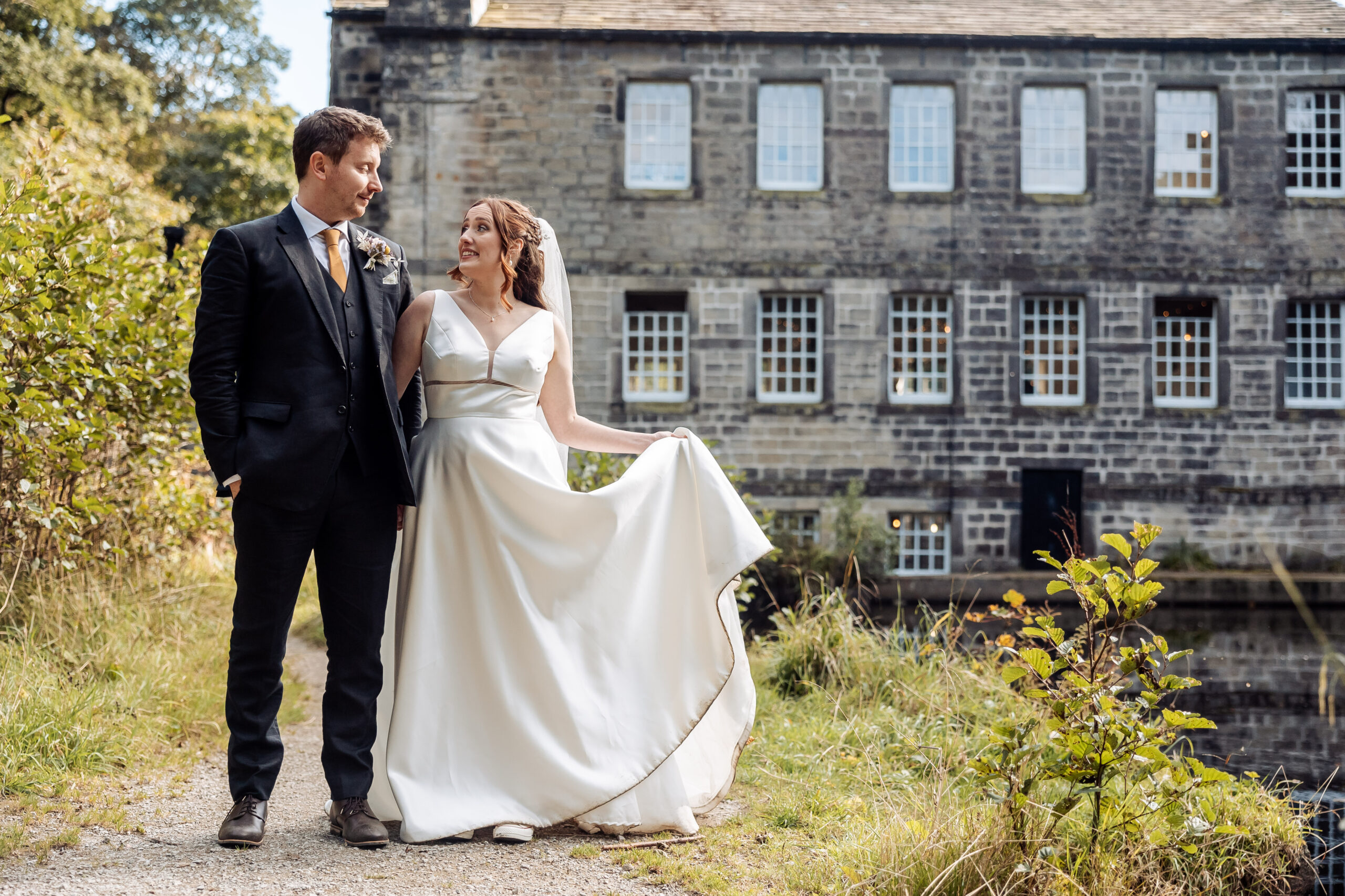 bride and groom with gibson mill in the rear